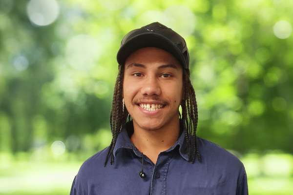 Kobe Miller smiling with bluer trees in his background