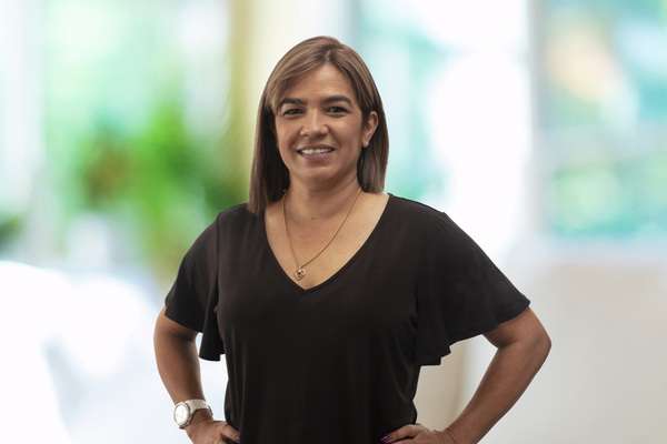 Metesha Cox smiling bluer background